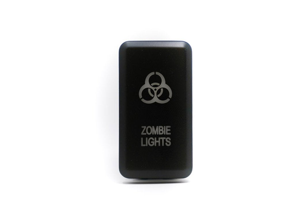 Black rocker switch with biohazard symbol and zombie lights text for off-road vehicle lighting