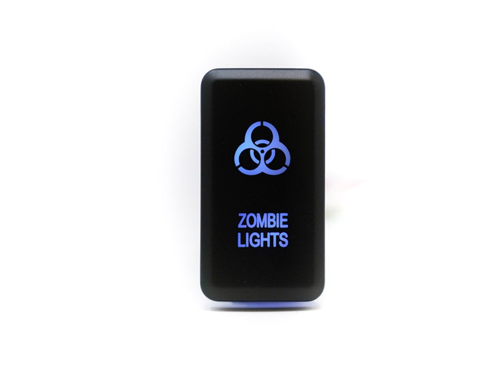 Black rocker switch with glowing blue biohazard symbol and 'Zombie Lights' text for off-road vehicles