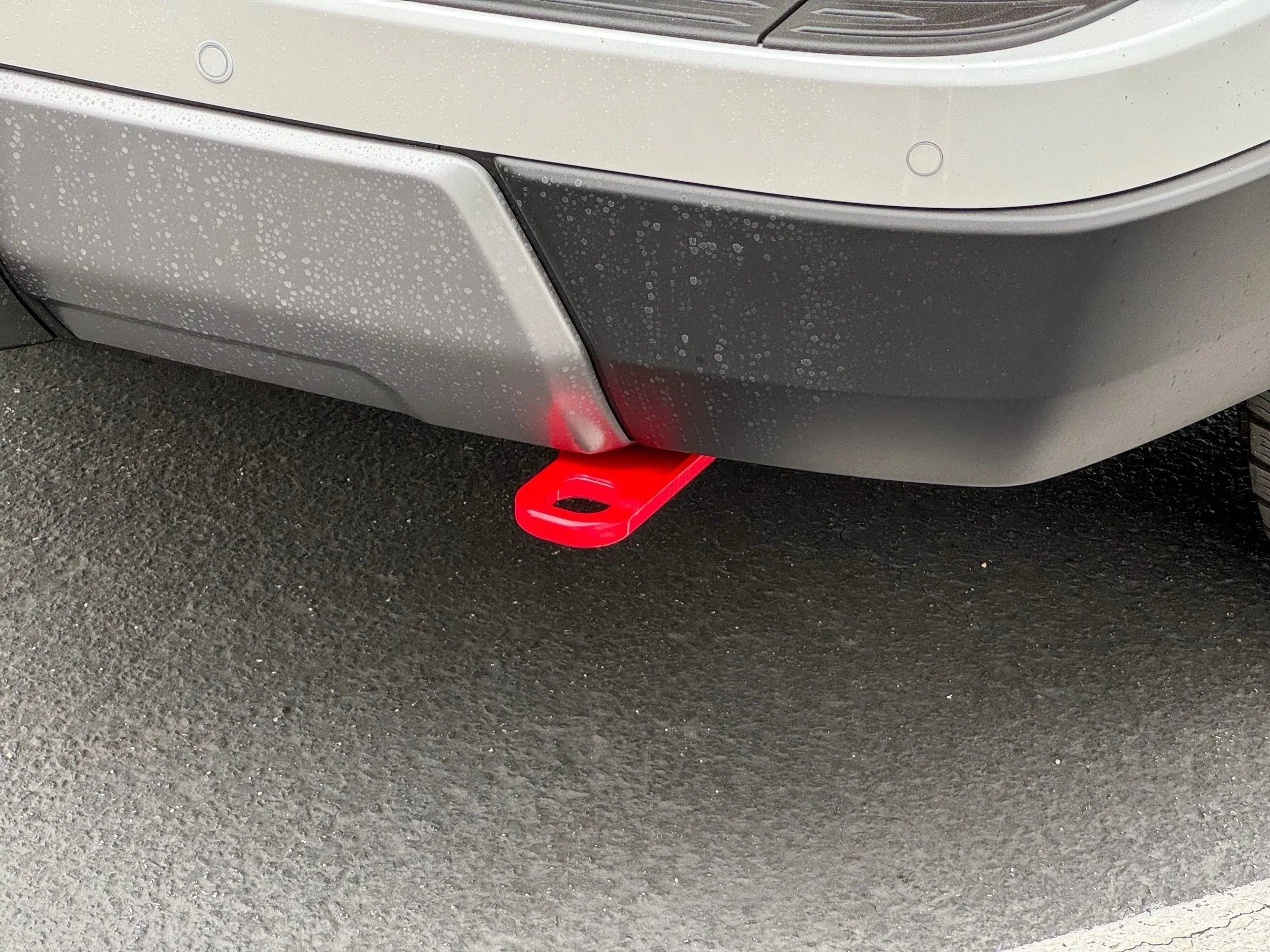 Red rear recovery point attached to SUV bumper, outdoor off-road accessory