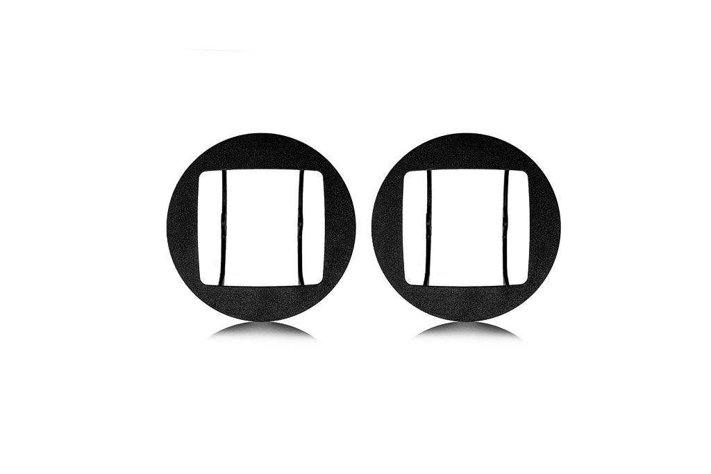 Pair of black metal fog light mounting brackets for Toyota Tacoma on white background