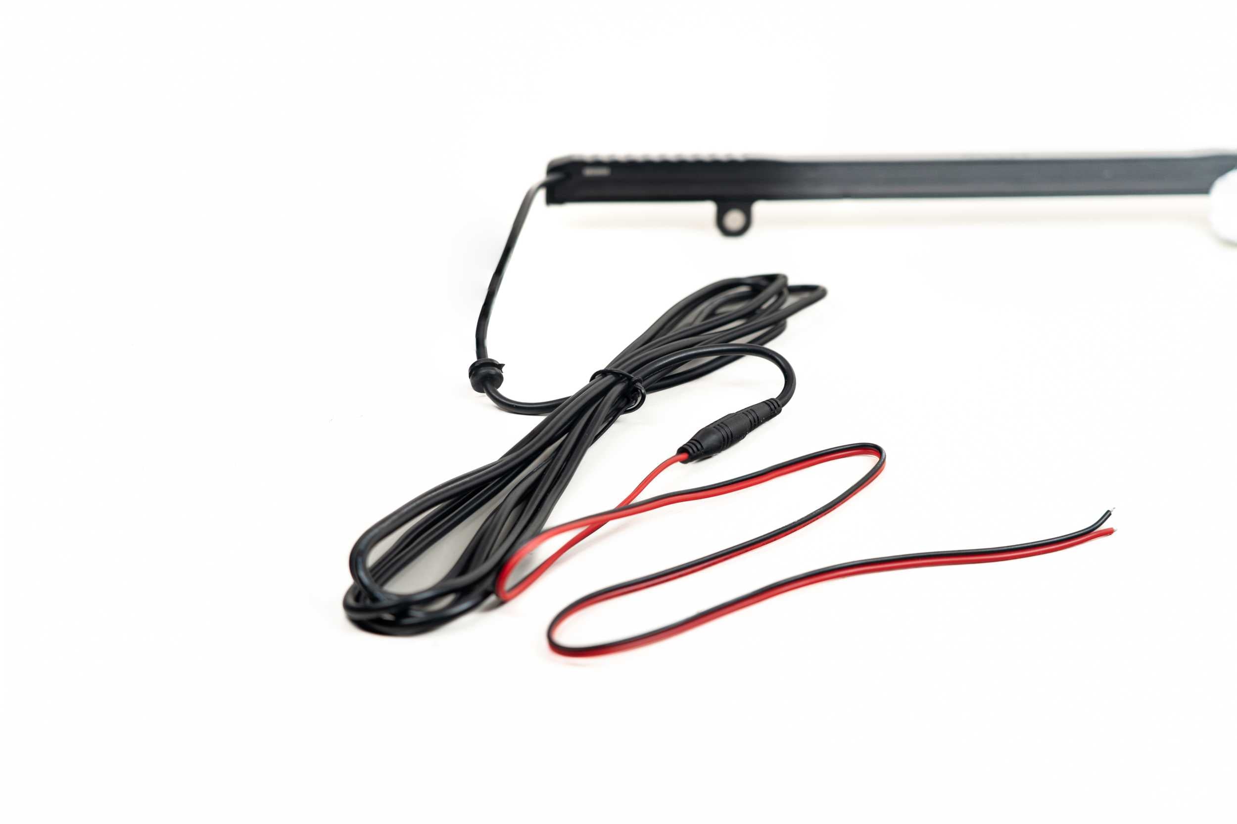 Black and red vehicle accessory wiring harness on white background