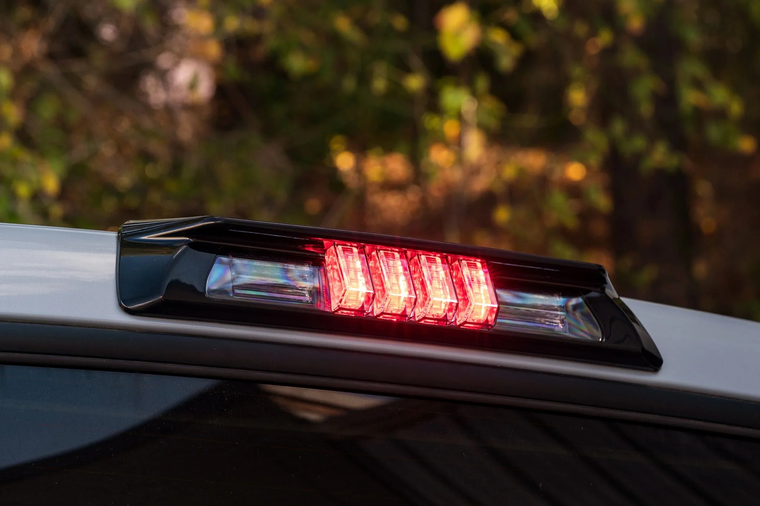LED truck third brake light mounted on rear cab, illuminated, outdoor setting