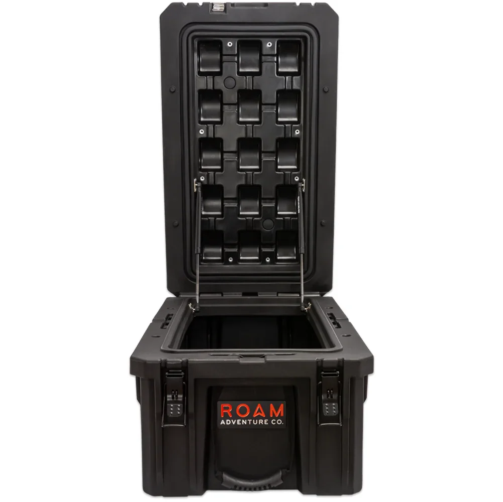 Open black hard storage case for overlanding and camping gear, shown upright with lid open
