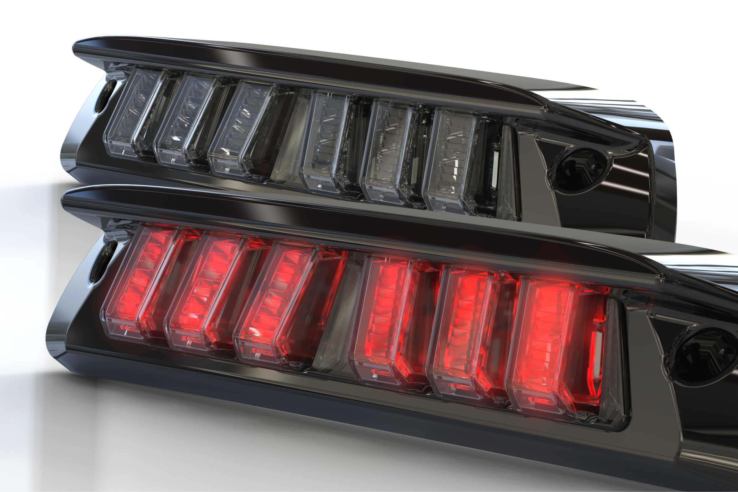 Pair of modern LED smoked rear tail lights with black housing, one illuminated red