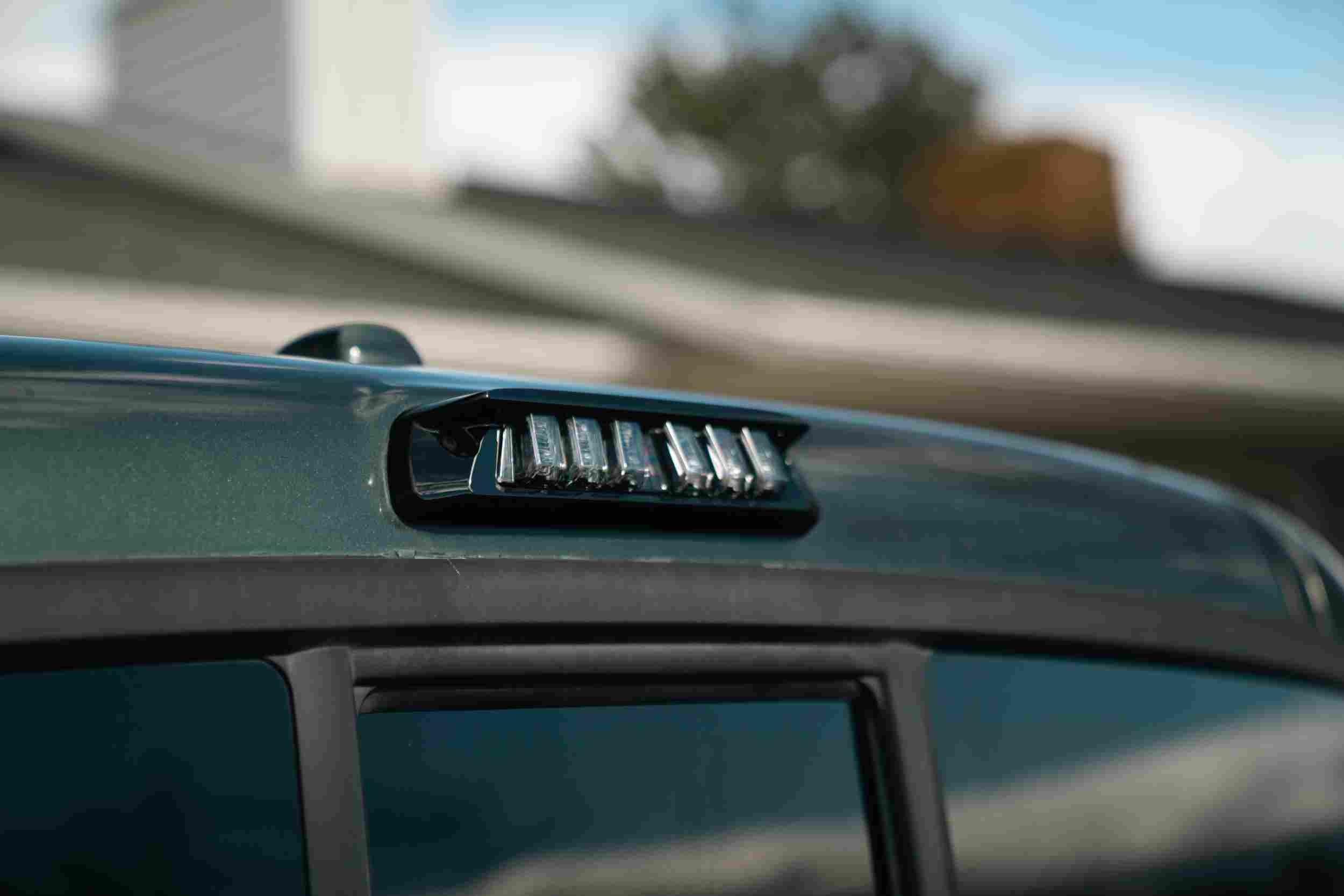 Close-up of LED roof cab light on a green off-road vehicle, outdoor setting
