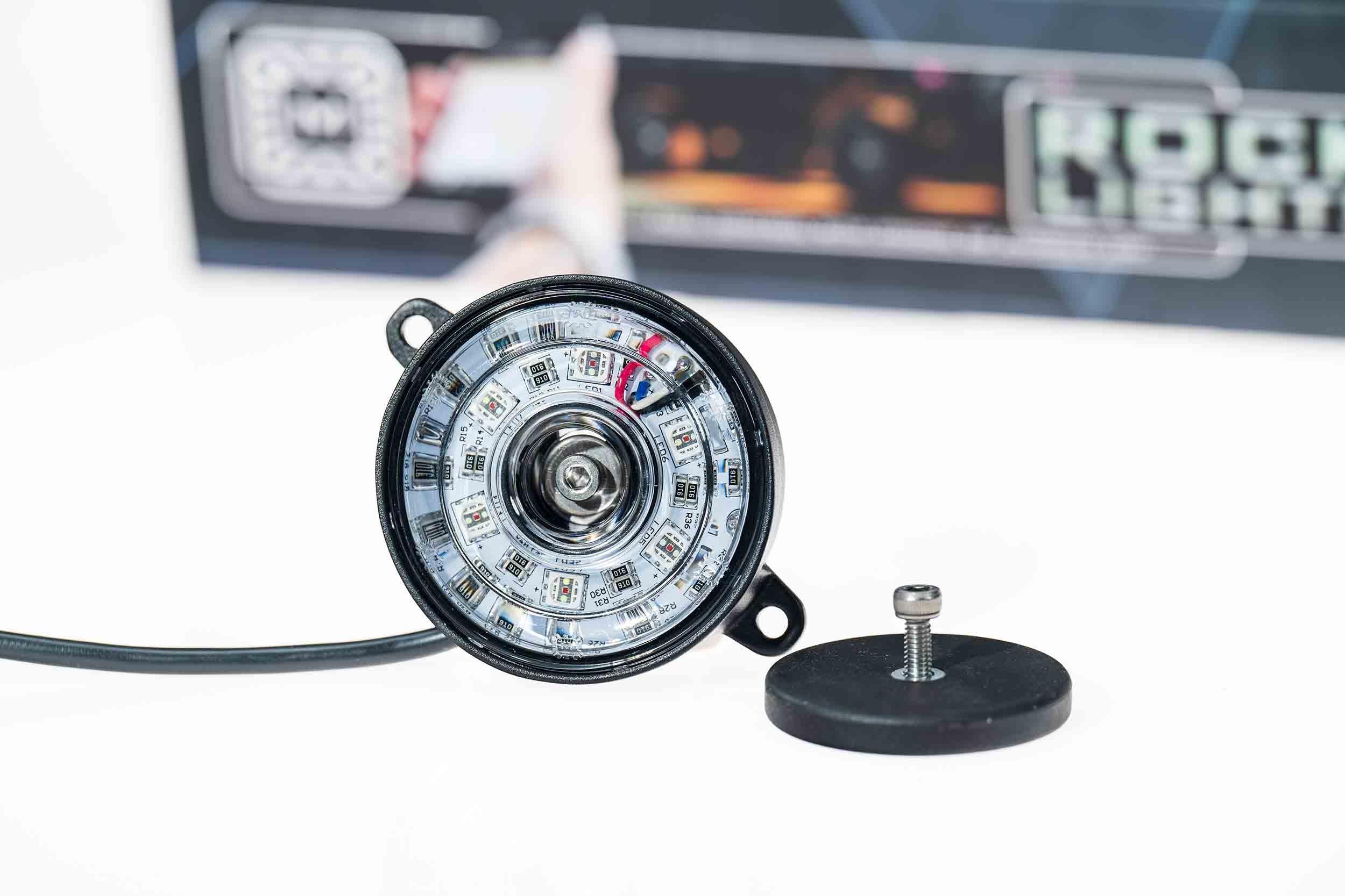 Round LED rock light with mounting hardware for off-road vehicles and overlanding gear