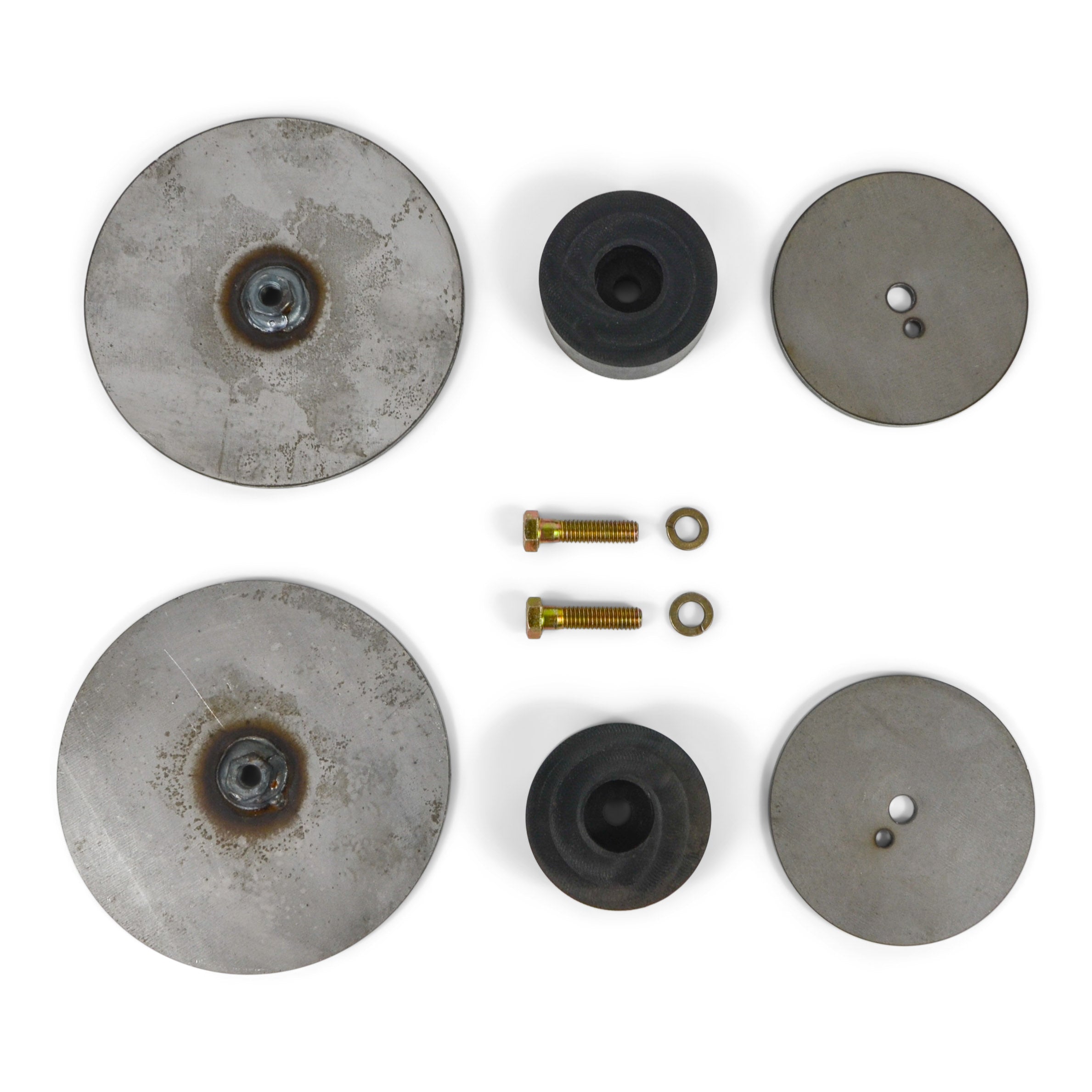 Vehicle suspension bump stop kit with metal plates, rubber spacers, bolts and washers.