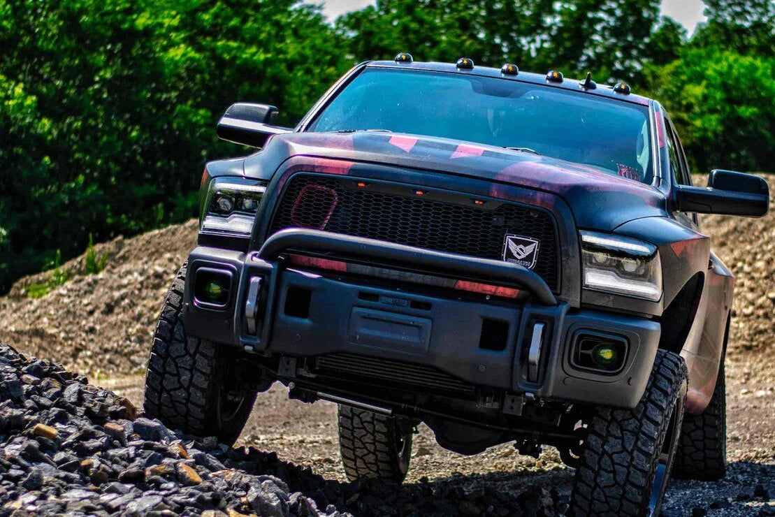Dodge Ram truck off-road with rugged tires and custom LED headlights