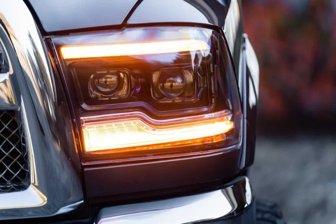 Close-up of RAM truck amber XB LED headlight with illuminated amber accents