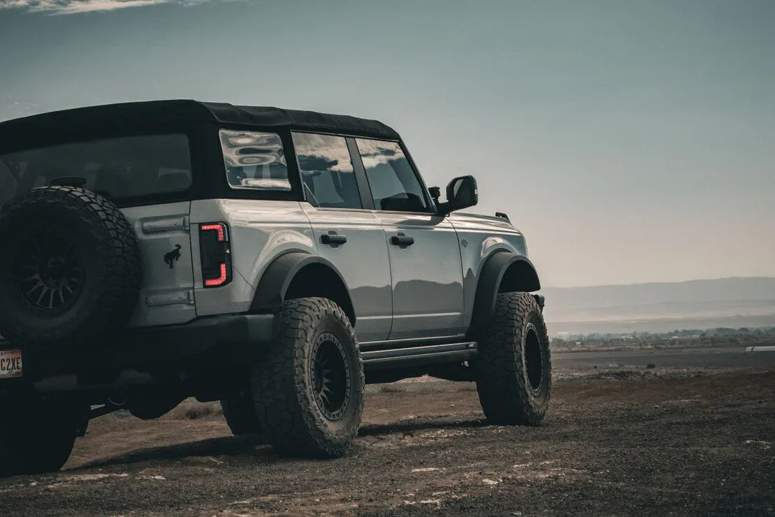 Lifted Ford Bronco SUV with off-road tires parked on rugged terrain
