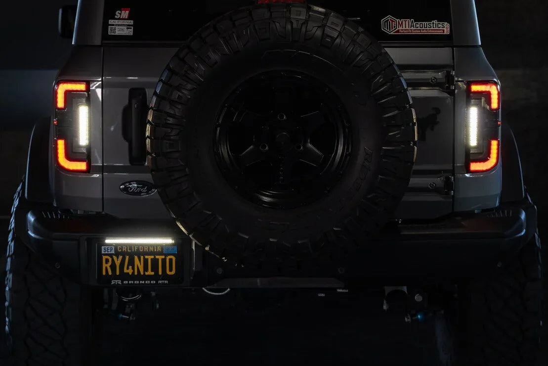Rear view of Ford Bronco with aftermarket spare tire and off-road accessories