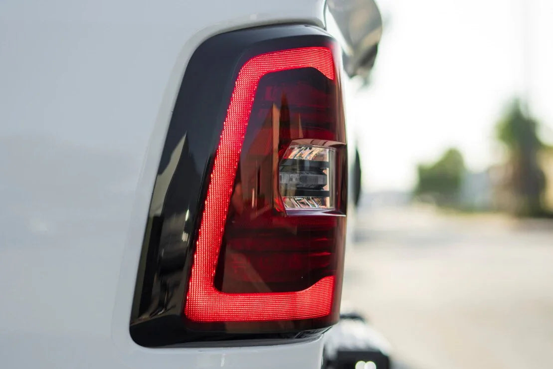 Close-up of LED taillight on white Toyota Tacoma, aftermarket truck accessory upgrade