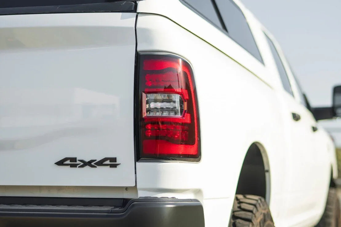 Close-up of white 4x4 off-road truck rear with taillight and rugged tire
