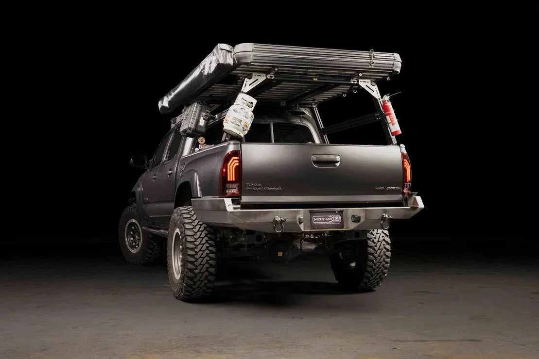 Toyota Tacoma outfitted with overlanding gear, rooftop tent, awning, and expedition accessories