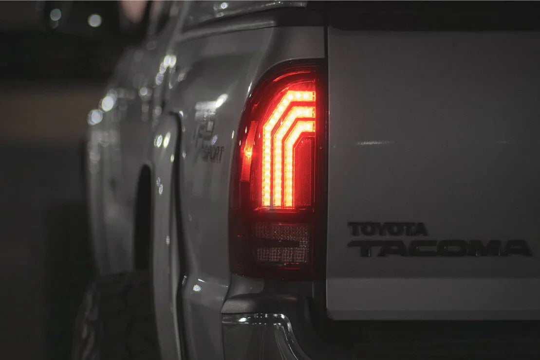 LED tail light on silver Toyota Tacoma truck at night