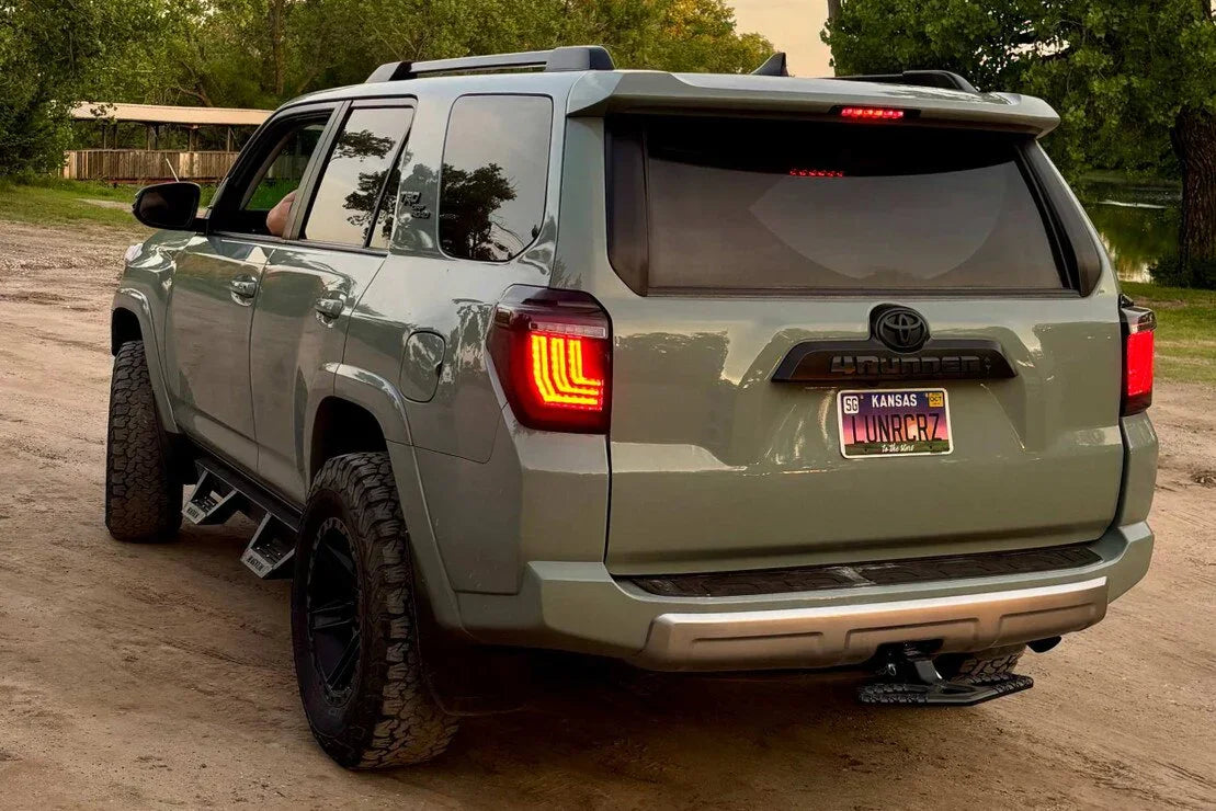 Toyota 4Runner SUV with off-road tires and aftermarket accessories parked on a dirt road