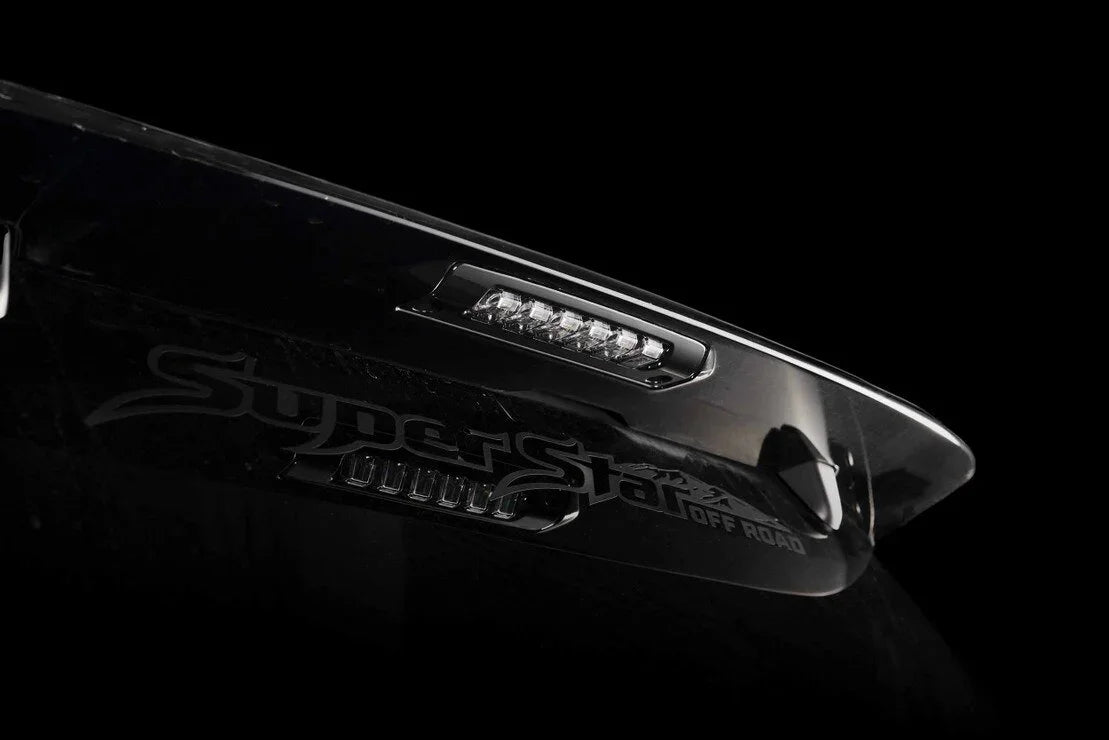 Close-up of black off-road truck visor with integrated LED light and Superstar Off Road logo.
