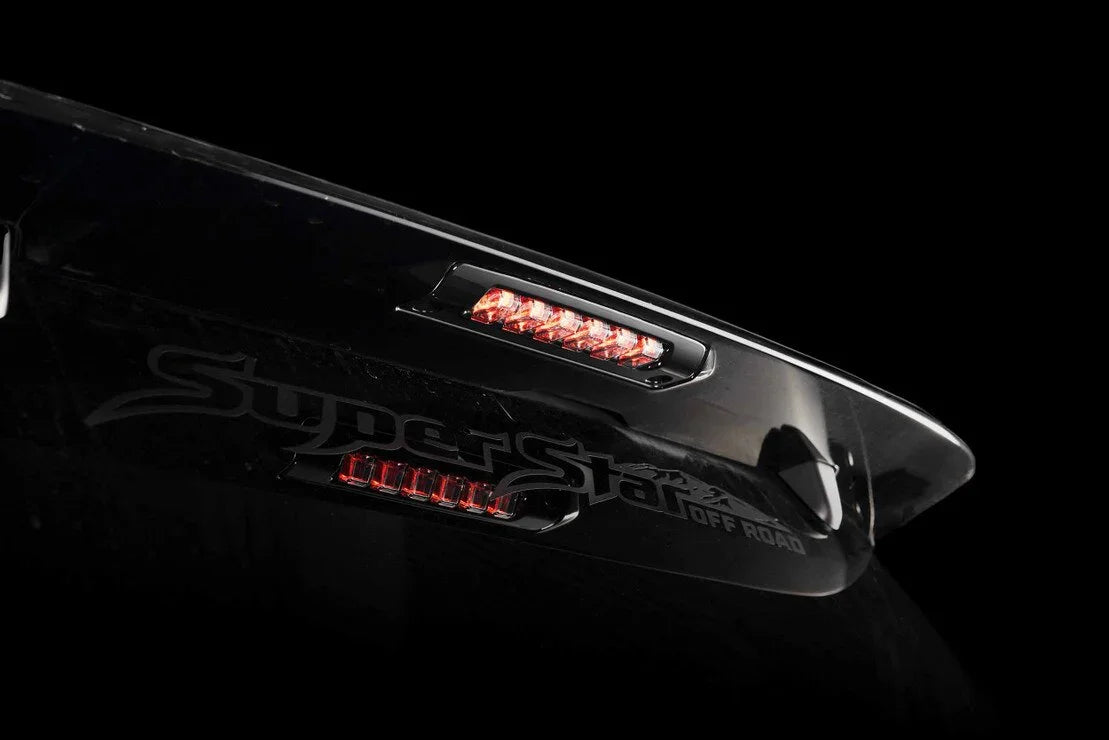 Close-up of off-road vehicle smoked LED third brake light and tailgate in dark setting