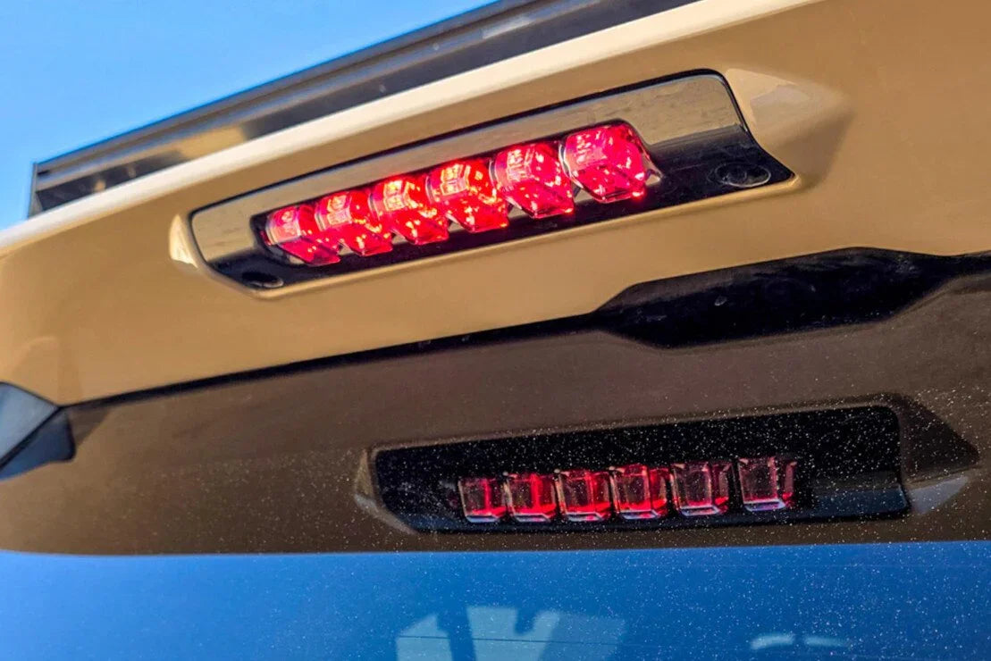Closeup of rear LED brake lights on an off-road vehicle with black trim