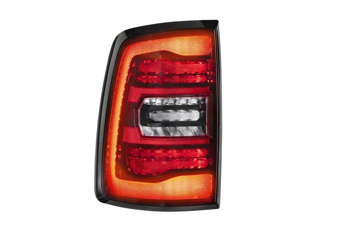 Red and clear Ram 1500 Classic LED tail light, close-up on white background.