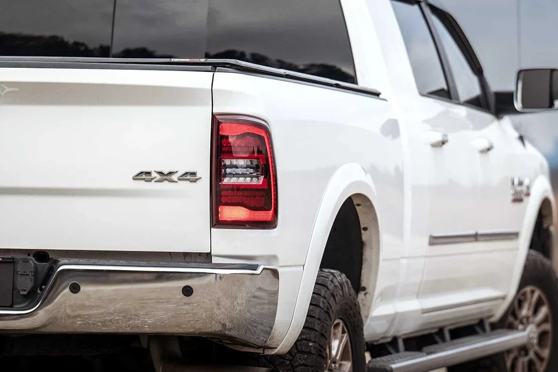 White Ram 1500 Classic 4x4 truck rear view with rugged tires for overlanding and camping