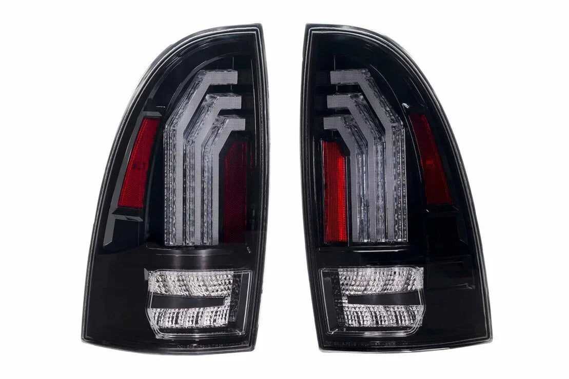 Pair of clear LED tail lights for Toyota Tacoma, black housing with red accents