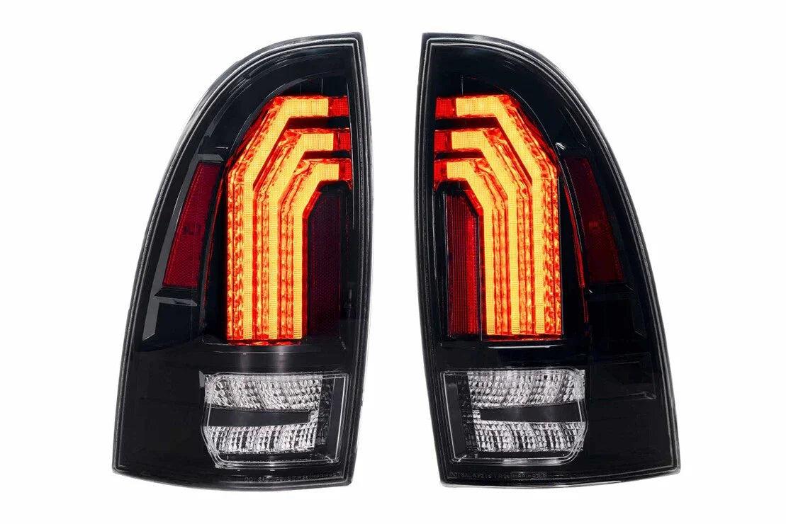 Pair of clear LED tail lights for Toyota Tacoma, black housing, red and white lighting