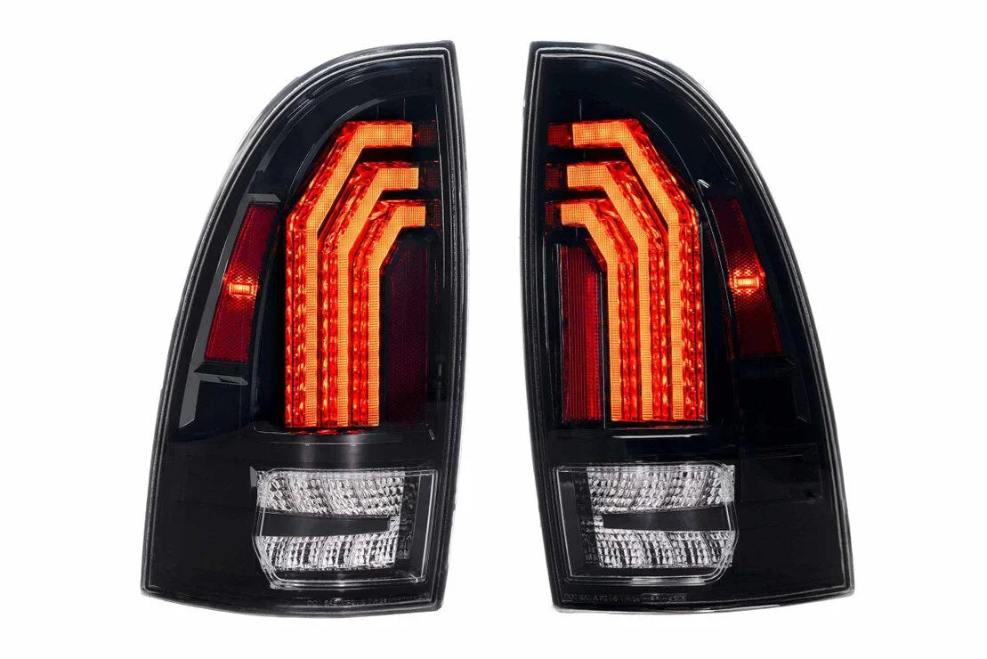 Pair of clear LED tail lights for Toyota Tacoma, black housing, red and white accents