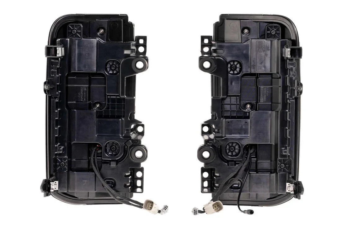 Rear view of two Ford Bronco smoked red tail light assemblies with wiring harnesses