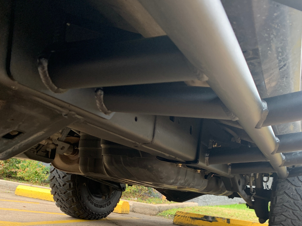 Heavy-duty rock sliders installed on off-road truck for overlanding protection