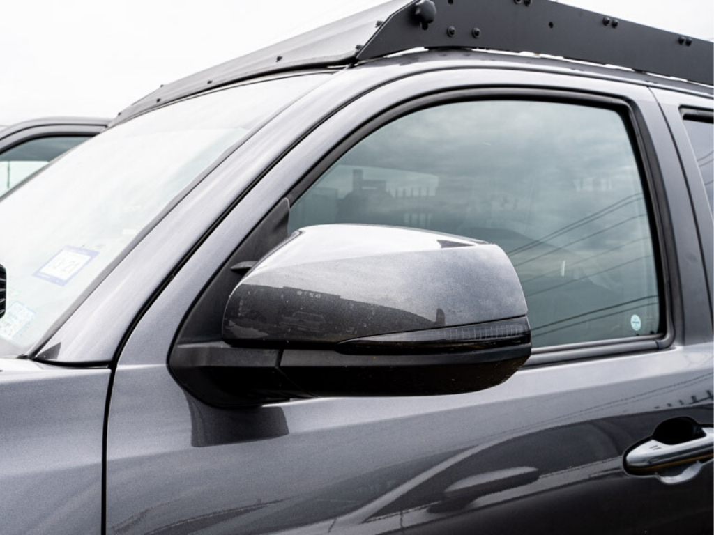 Close-up of side mirror and roof rack on overland-ready Toyota SUV