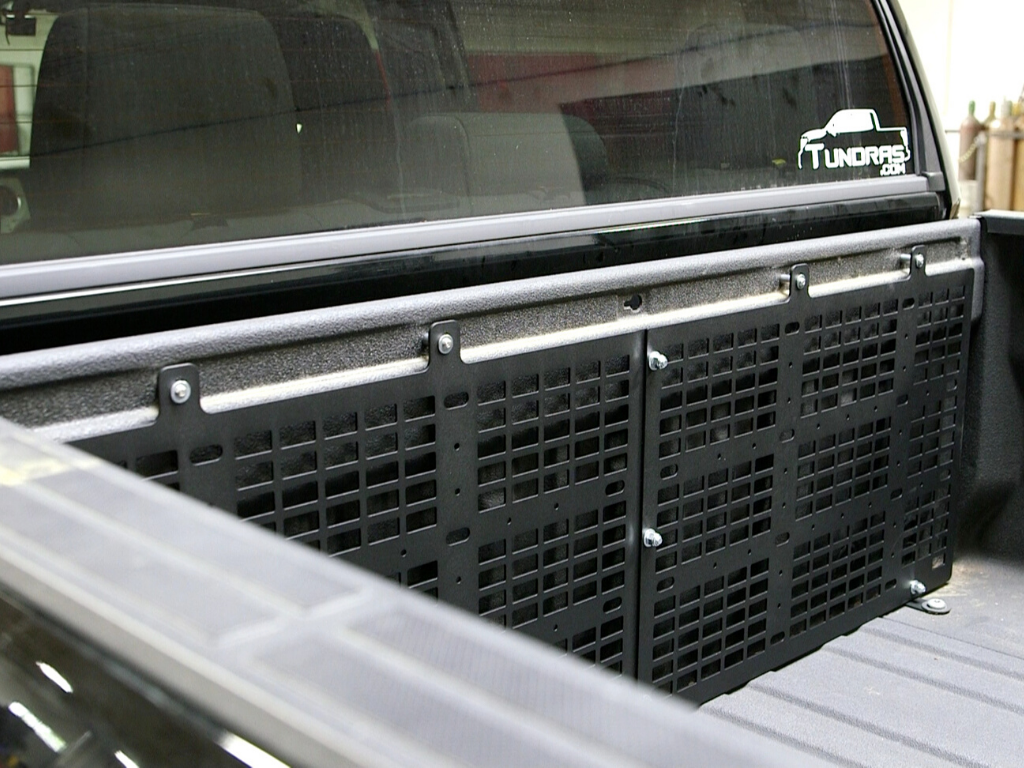 Black steel bed rack panel mounted in Toyota Tundra truck bed for overlanding gear storage.