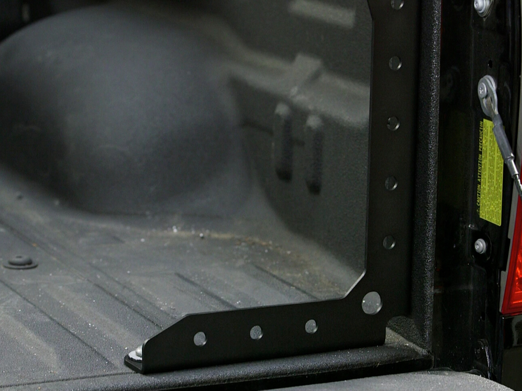 Heavy-duty overland bed rack mounting bracket installed in truck bed