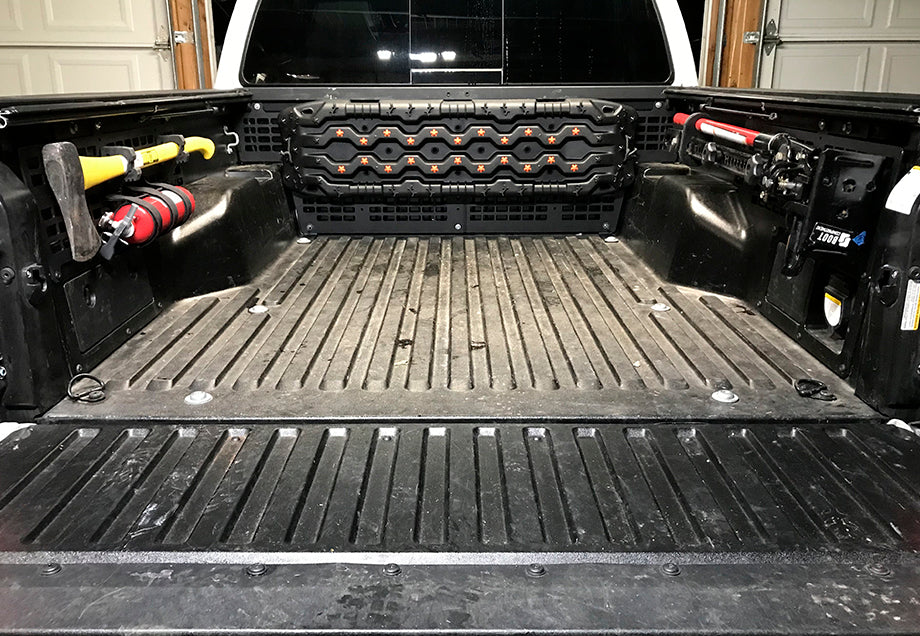 Toyota Tacoma bed with MOLLE panel system, mounted tools and gear storage accessories