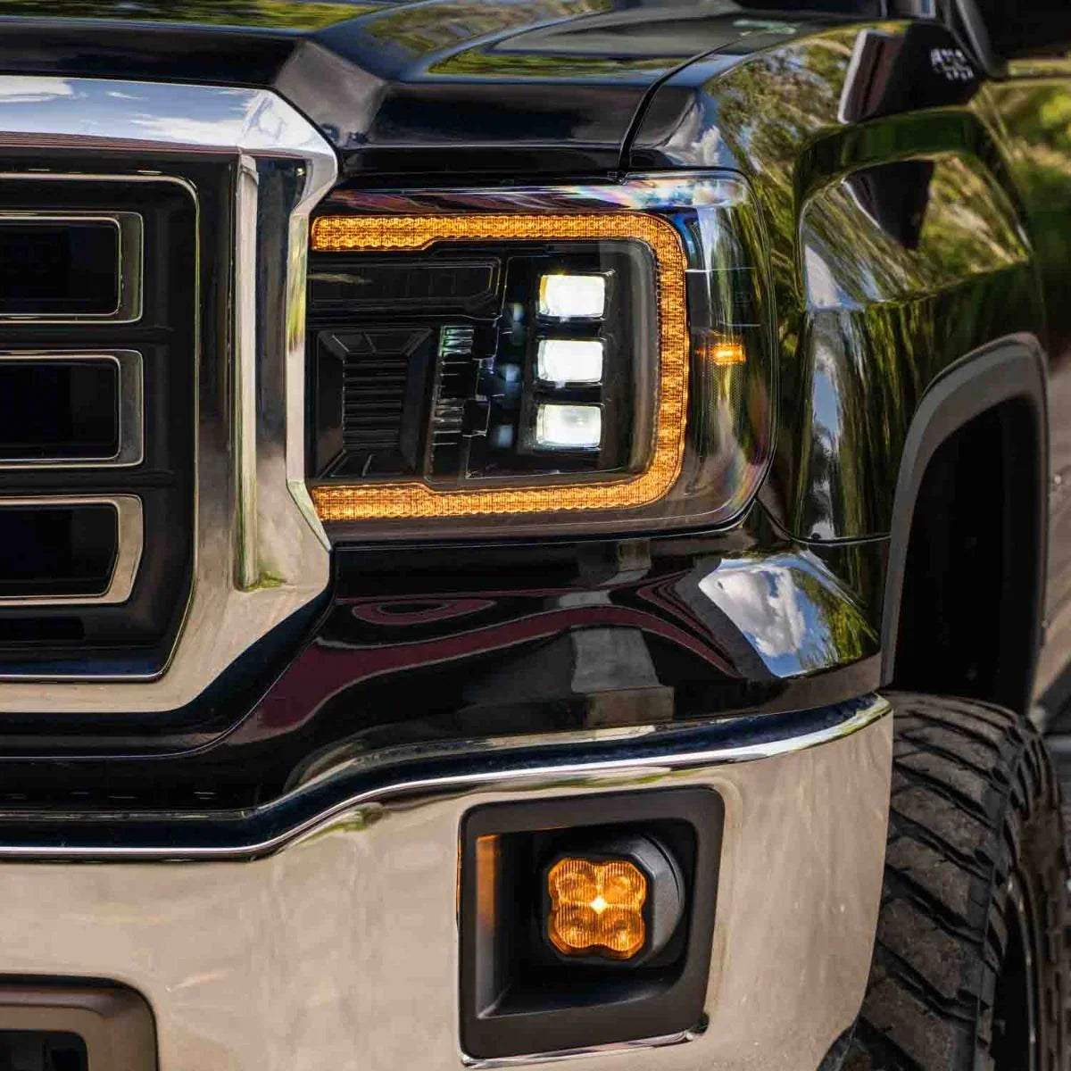 2015 GMC Sierra 1500 smoked amber LED headlight and high beam close-up