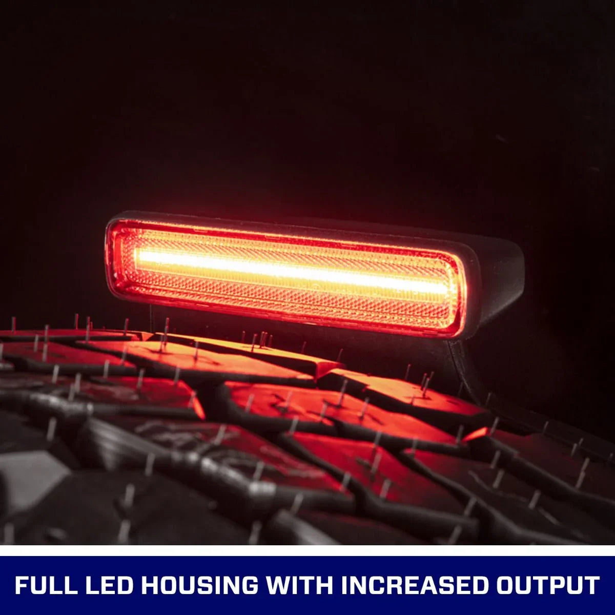 LED third brake light for Jeep Wrangler JL above rear tire, illuminated in red.