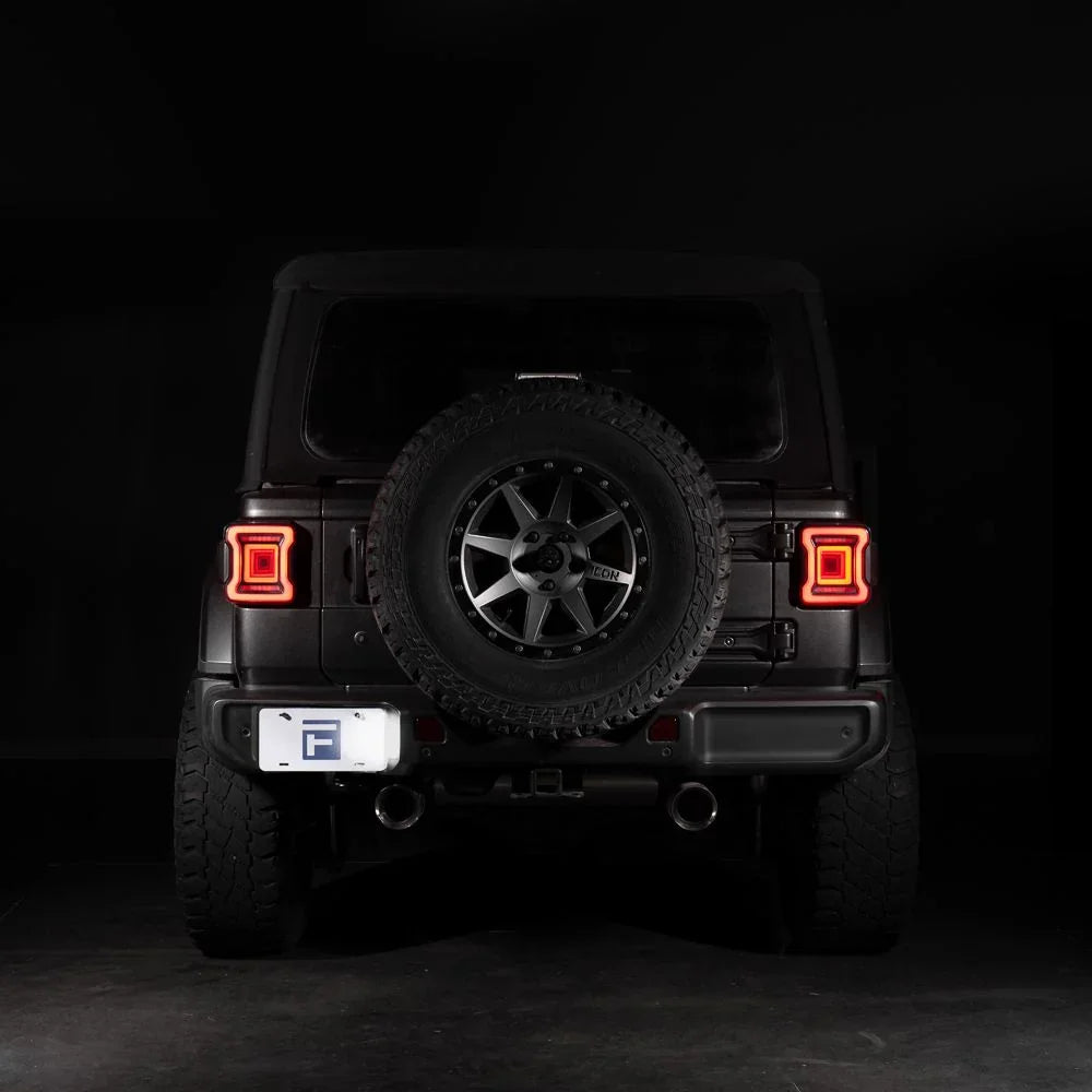 2018 Jeep Wrangler rear view with aftermarket LED tail lights, spare tire mount, dark background