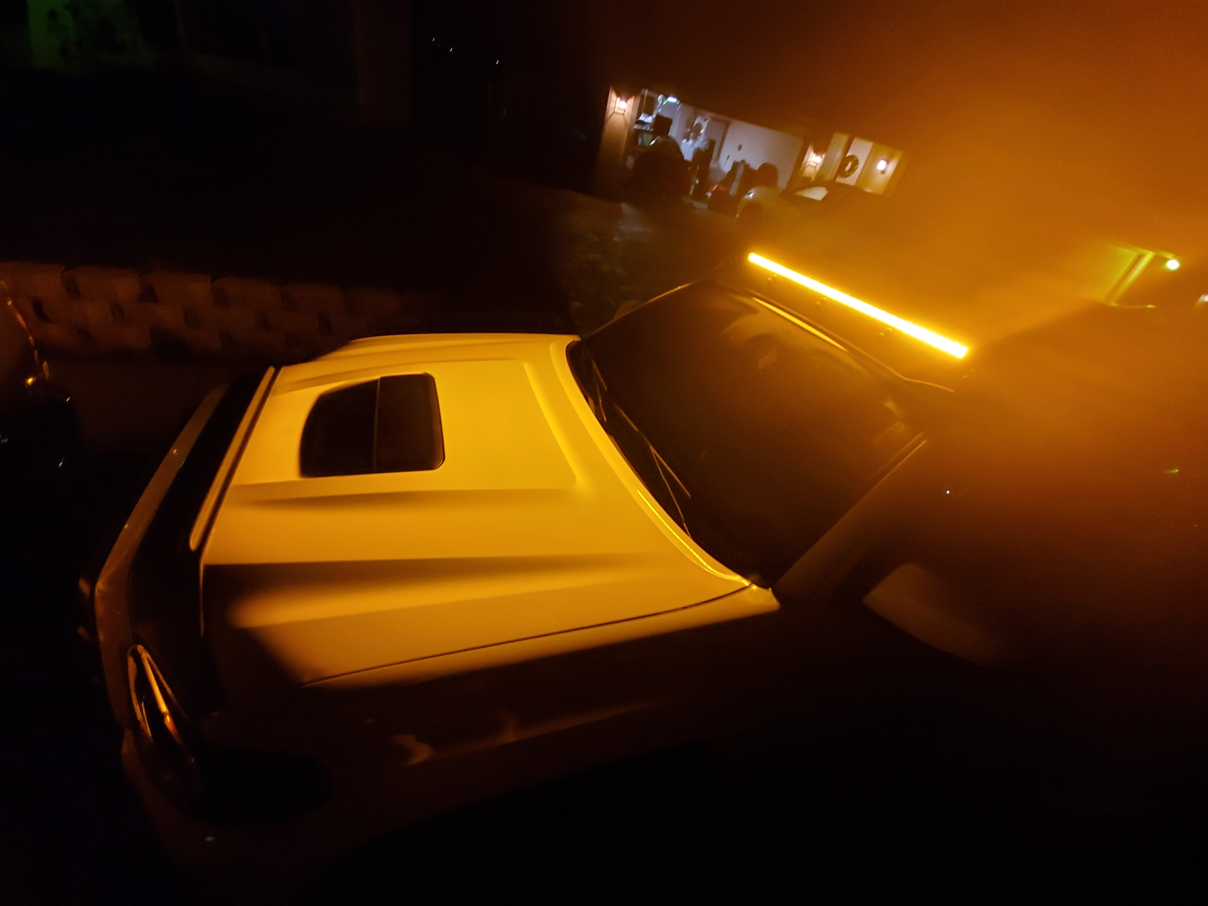 Toyota Tacoma with LED roof light bar illuminated at night, overlanding vehicle accessory