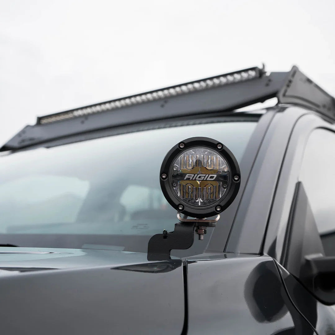 Toyota Tacoma with installed ditch light bracket and Rigid LED light, close-up view