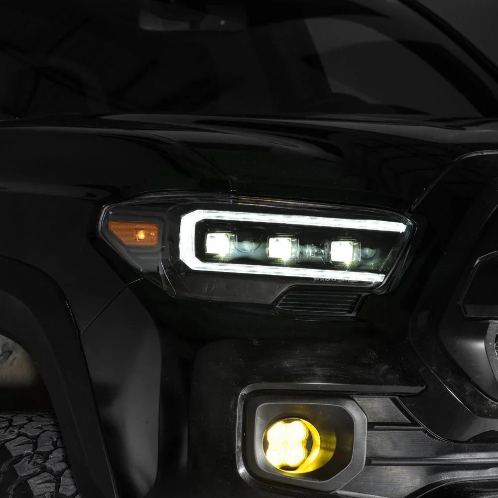 Close-up of 2021 Toyota Tacoma LED headlight with white DRL and yellow fog light
