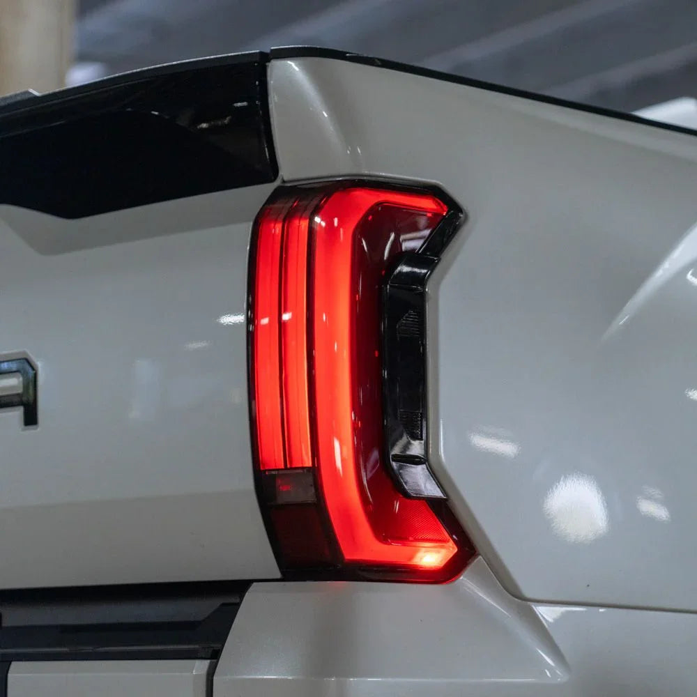 Close-up of 2024 Toyota Tundra LED tail light on white truck in parking garage