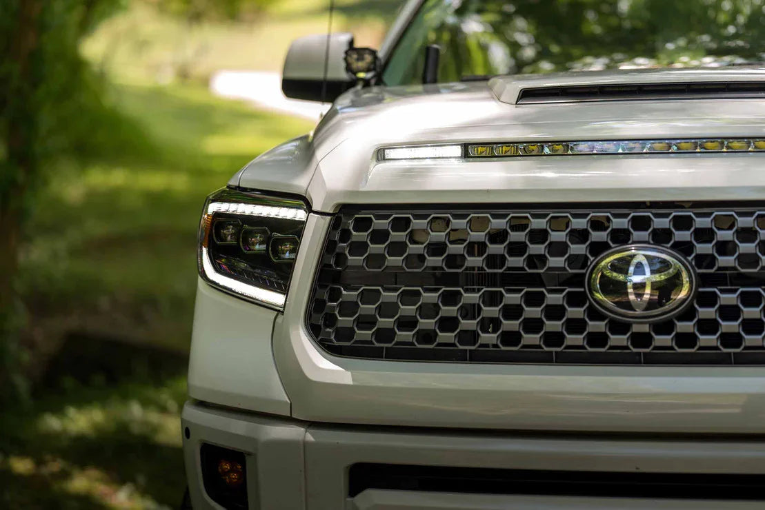 Toyota Tundra with XB LED headlights and custom grille, outdoor setting