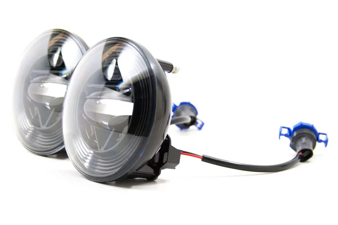 Pair of Morimoto XB LED fog lights with wiring for Jeep Wrangler JL, close-up on white background.