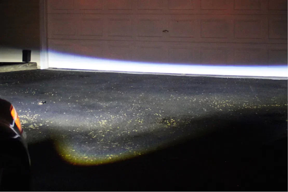 Jeep Wrangler JL Morimoto XB LED headlights beam pattern against a garage door at night