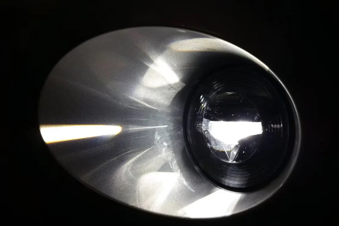 Close-up of Jeep Wrangler JL Morimoto XB LED headlight reflecting bright light