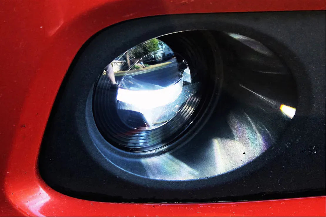 Close-up of Jeep Wrangler JL Morimoto XB LED fog light on red vehicle bumper