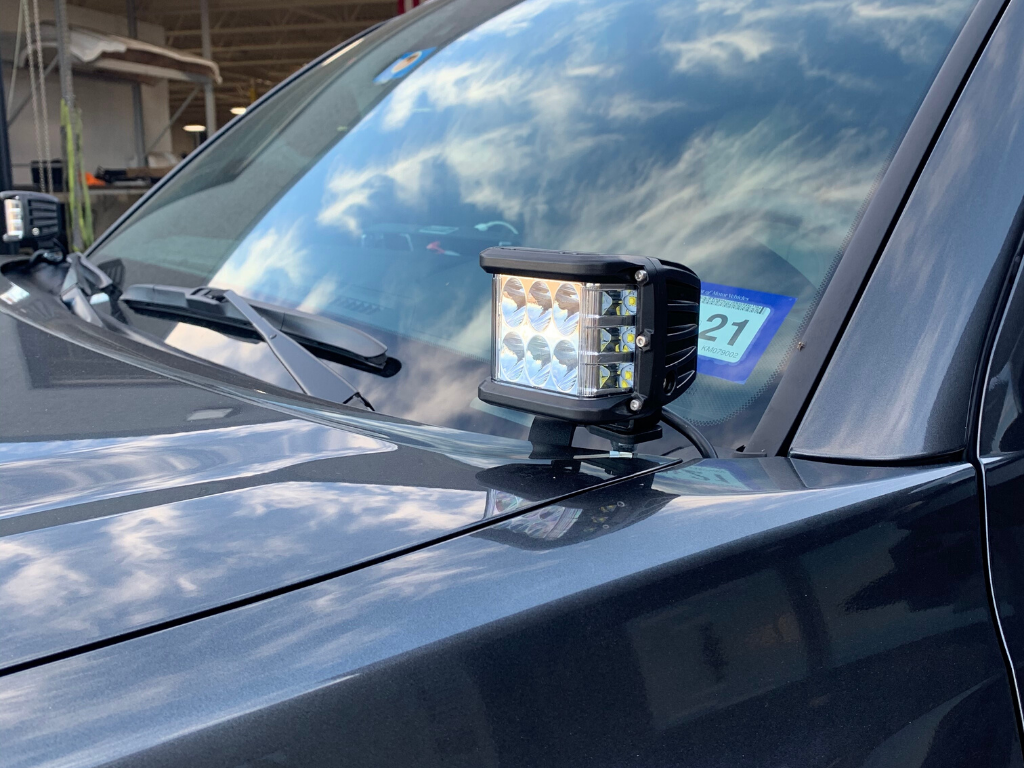 LED offroad pod light mounted on the hood of a gray overlanding vehicle
