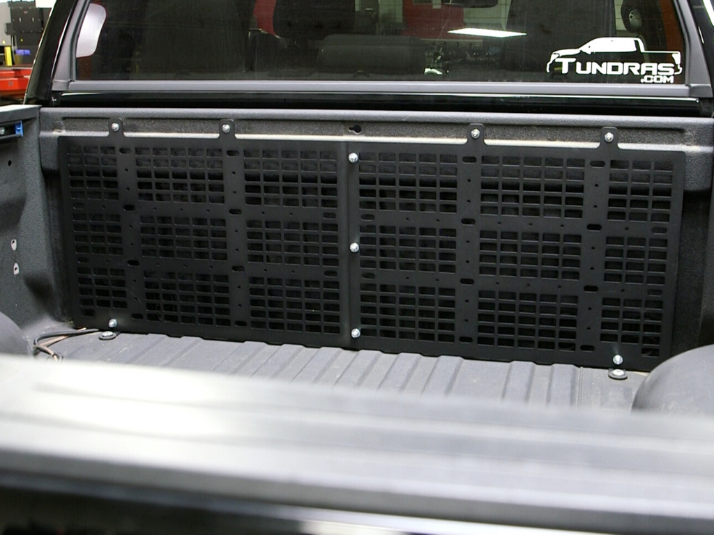 Toyota Tundra bed with black modular cargo panel for overlanding gear organization