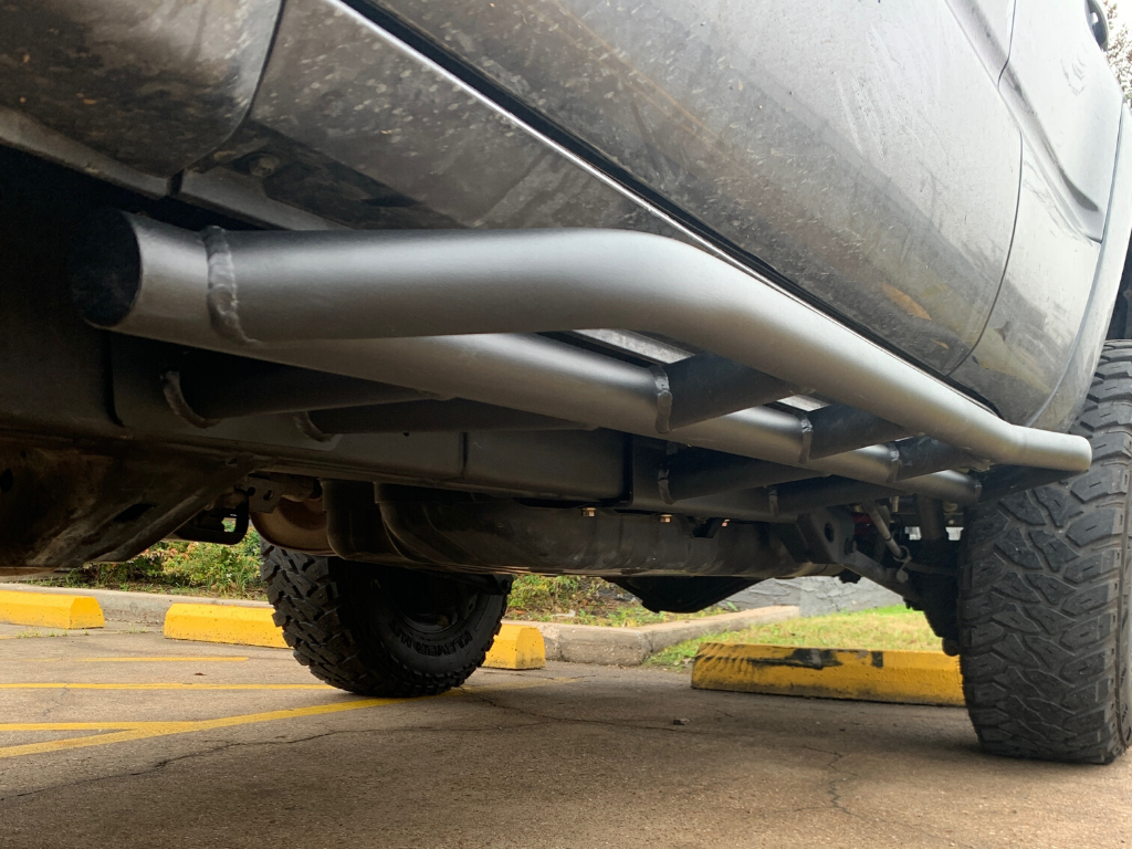 Heavy-duty rock sliders installed on an off-road vehicle for overlanding protection