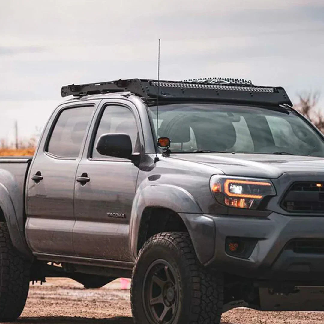 2nd gen Toyota Tacoma with ditch light brackets and roof rack for off-road use
